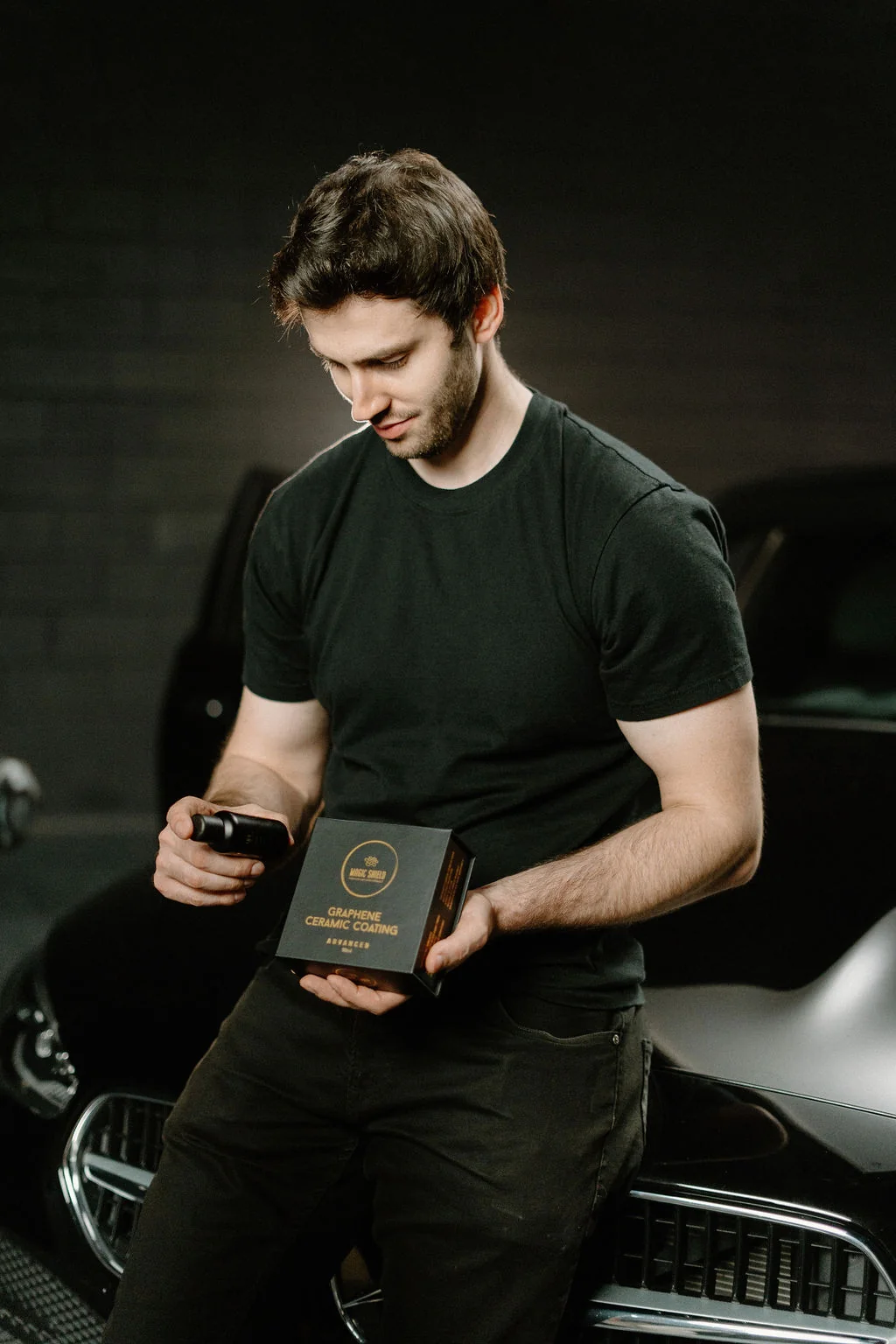 A Magic Shield coating kit beside a vehicle